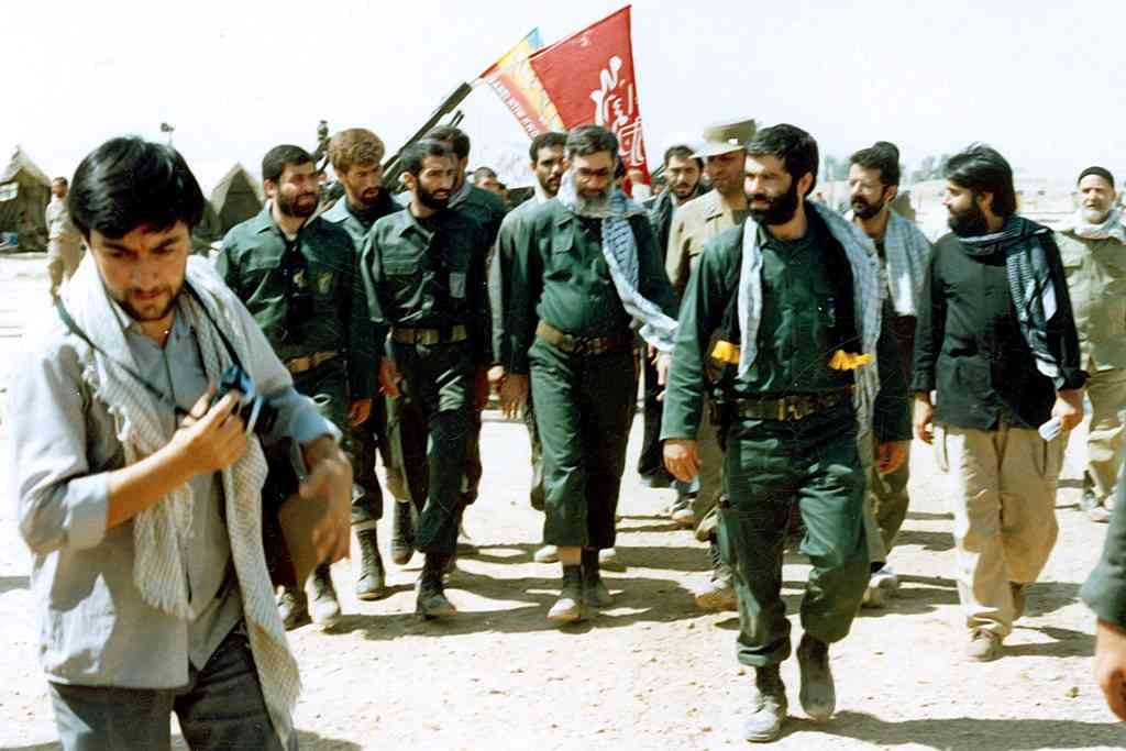 The then Iranian President Ali Khamenei visits a battlefield