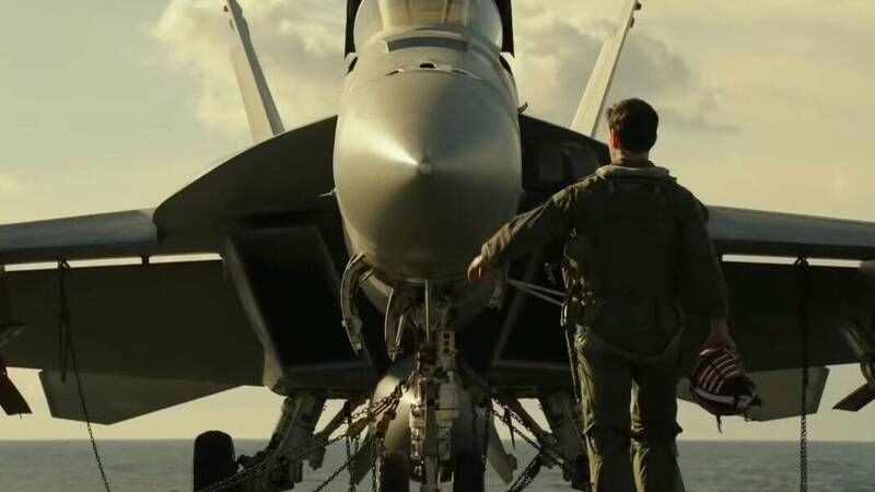 Tom Cruise looking at fighter jet in Top Gun Maverick